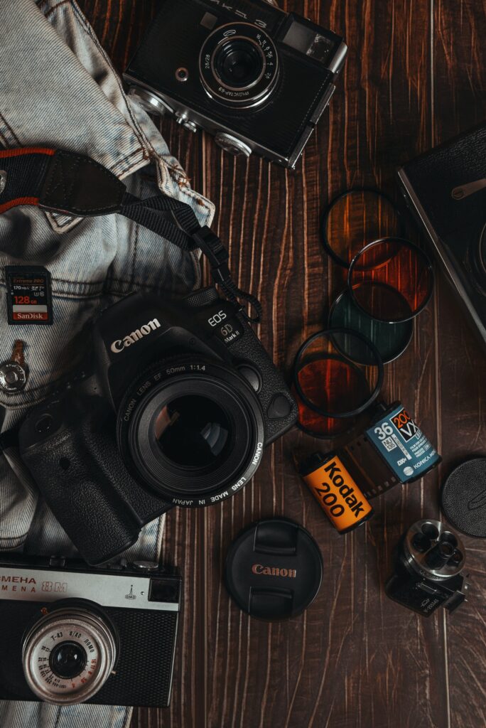 Canon Camera and Kodak Film on table. Photo by Sergey Sokolov on Unsplash.